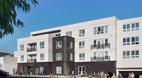 an image of a building with people walking in front of it