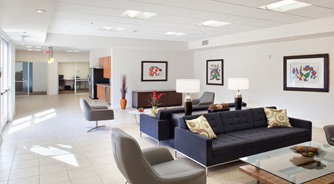 a living room with couches and chairs and a table