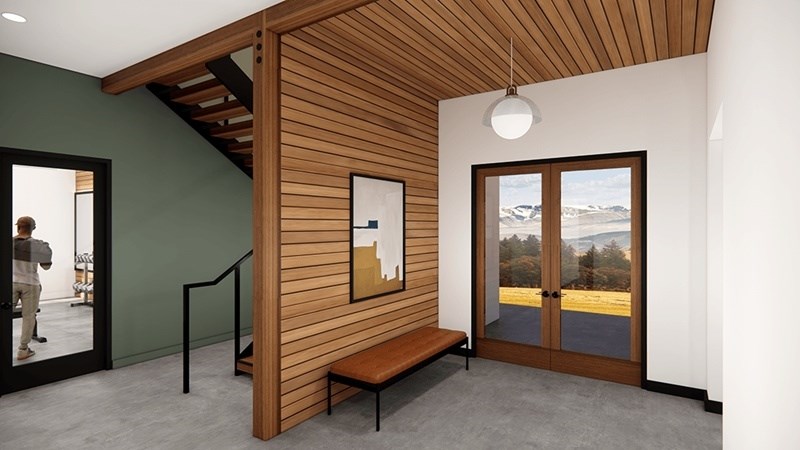 A person is walking into a room with a wooden staircase. at 38° NORTH, Santa Rosa, California