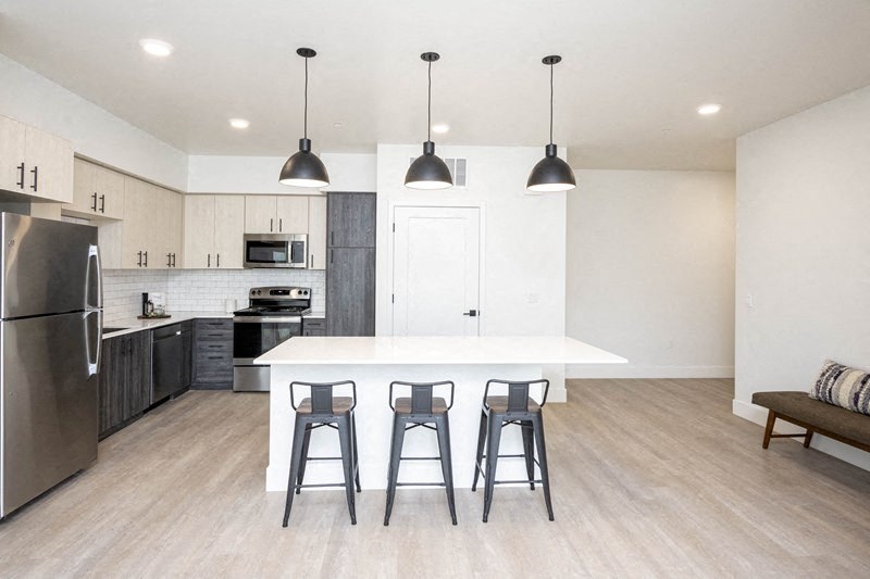 A kitchen with a white island and black bar stools. at 38° NORTH, Santa Rosa, California