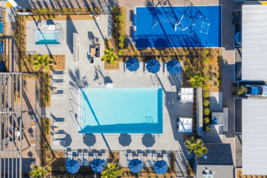 arial view of a resort pool with blue umbrellas and chairs at 38° NORTH, Santa Rosa, CA