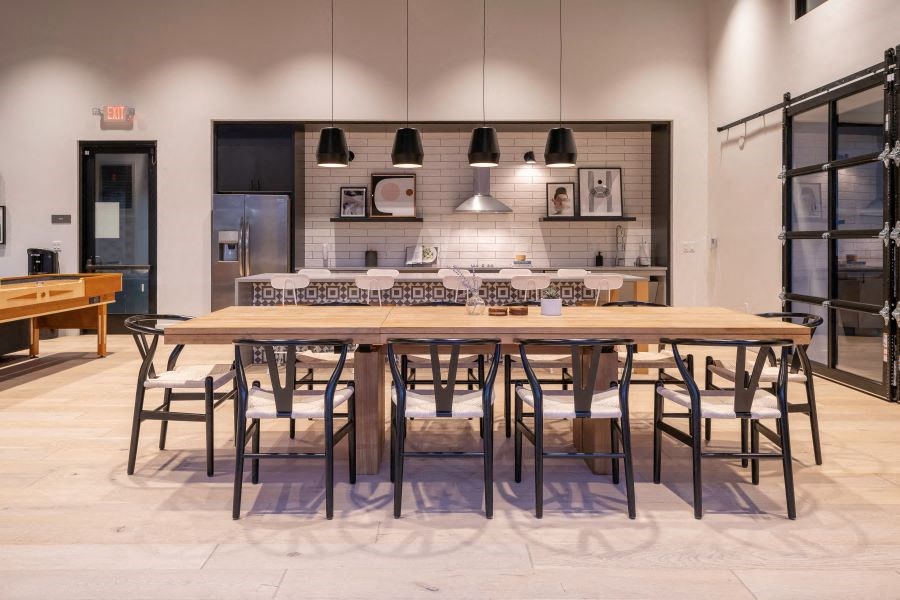 a large wooden table with chairs and a kitchen in the background at 38° NORTH, Santa Rosa, 95404