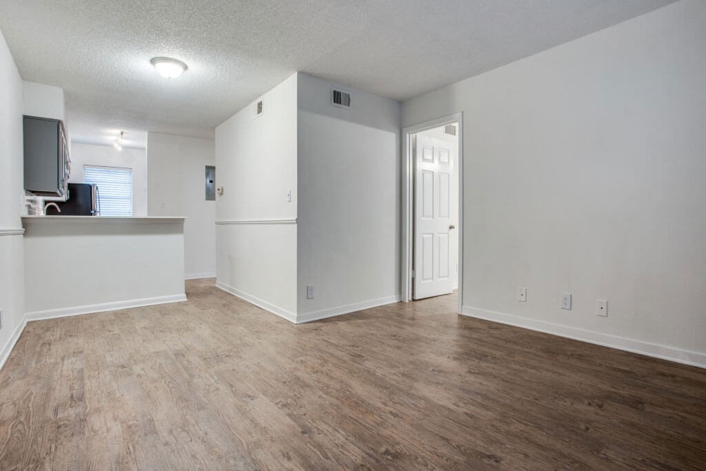 empty living room with a kitchen in the background at THE EASTWOOD, Texas