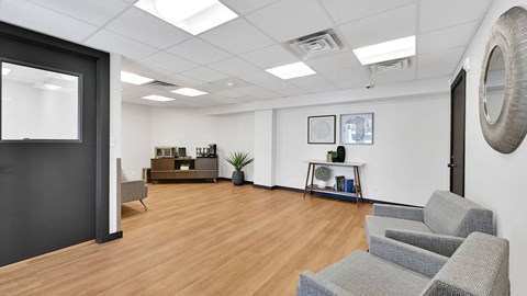 A room with a grey sofa and a wooden floor.