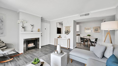 A modern living room with a fireplace and a grey sofa.