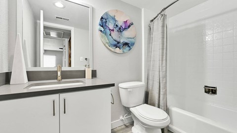 A white toilet sits next to a sink in a bathroom.