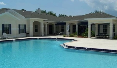A house with a pool in front.