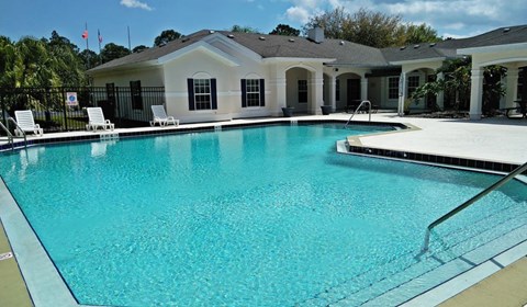A swimming pool in front of a house.