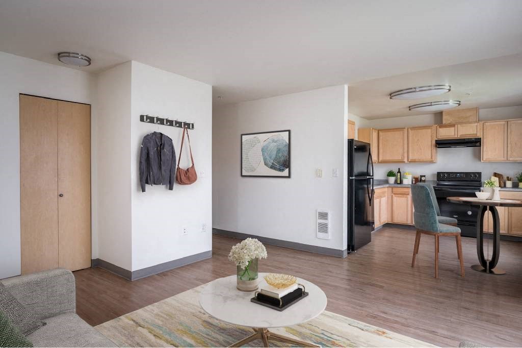 a living room with a kitchen and a table at Fort Vancouver Terrace, Vancouver, WA