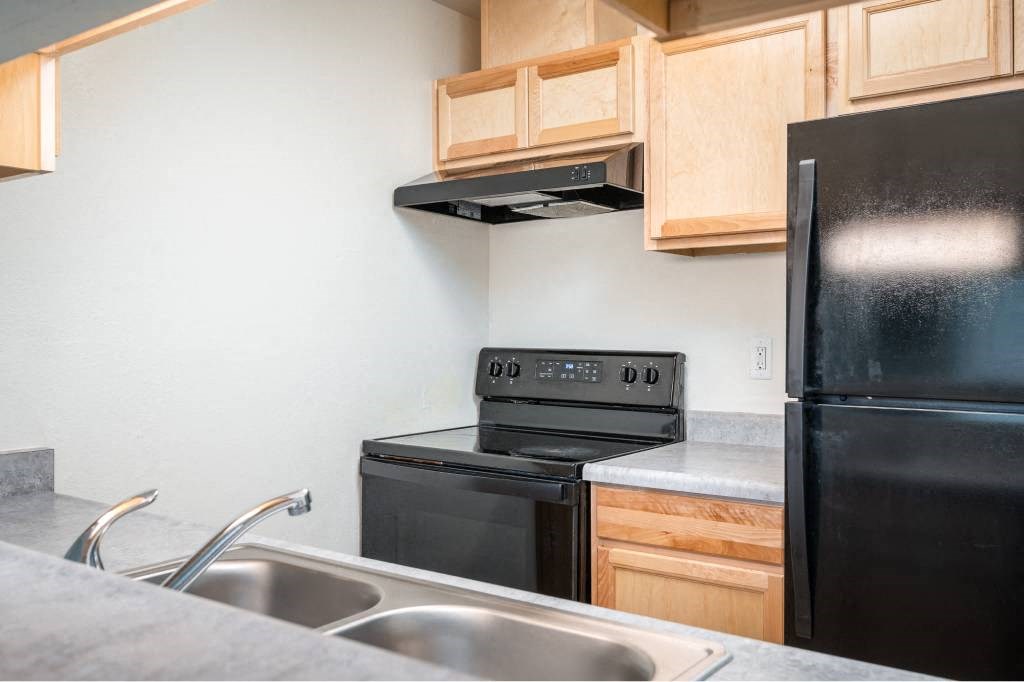 a kitchen with a sink stove and refrigerator at Fort Vancouver Terrace, Vancouver, 98661