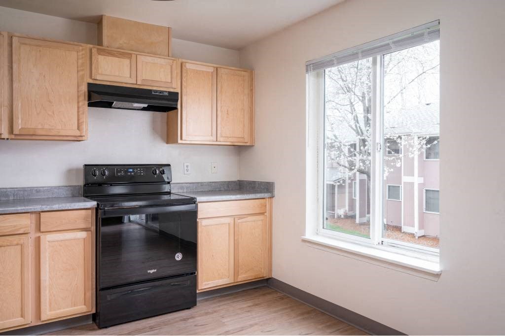 a kitchen with a black stove and a window at Fort Vancouver Terrace, Washington