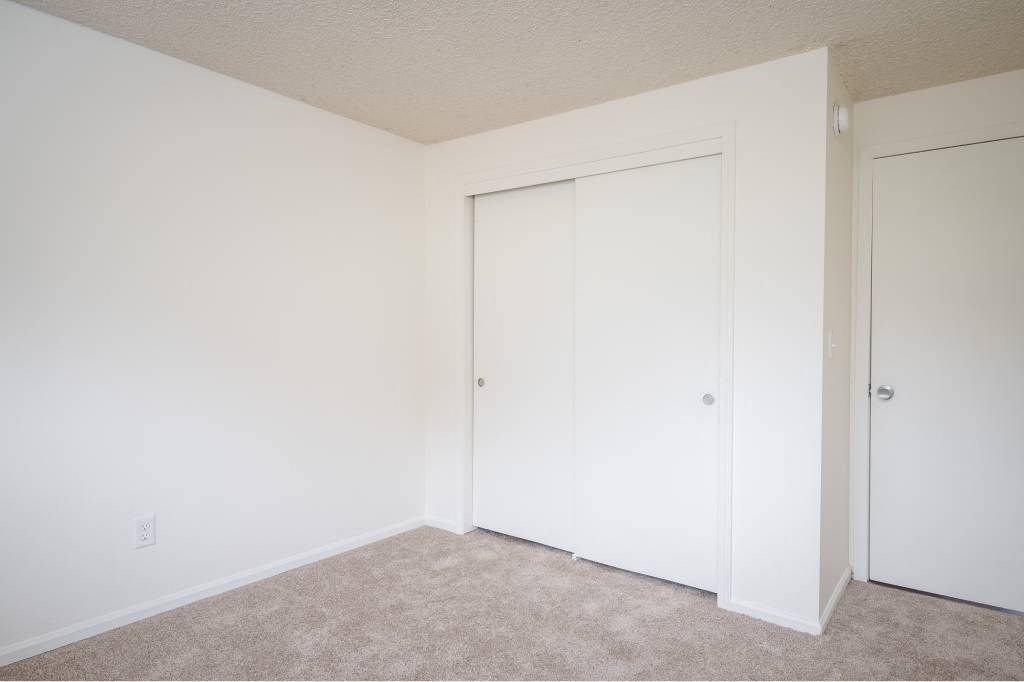 a bedroom with two closets and a carpeted floor at Fort Vancouver Terrace, Washington, 98661