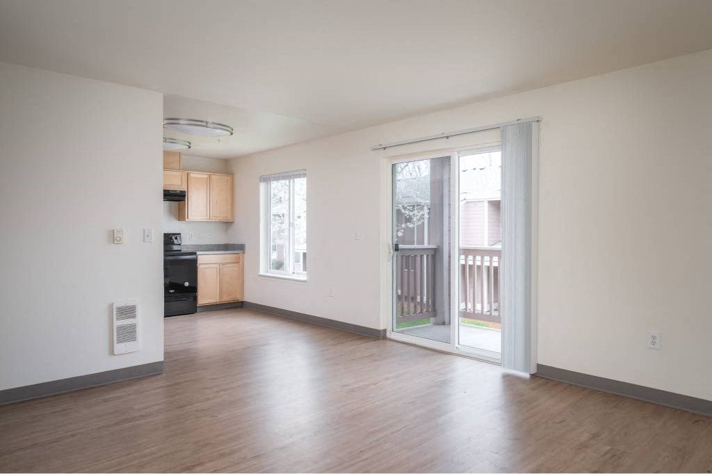 an empty living room with a door to a balcony at Fort Vancouver Terrace, Vancouver, 98661