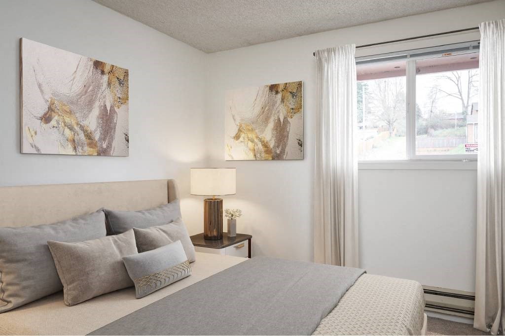 a bedroom with a bed with pillows and a window at Fort Vancouver Terrace, Vancouver, WA