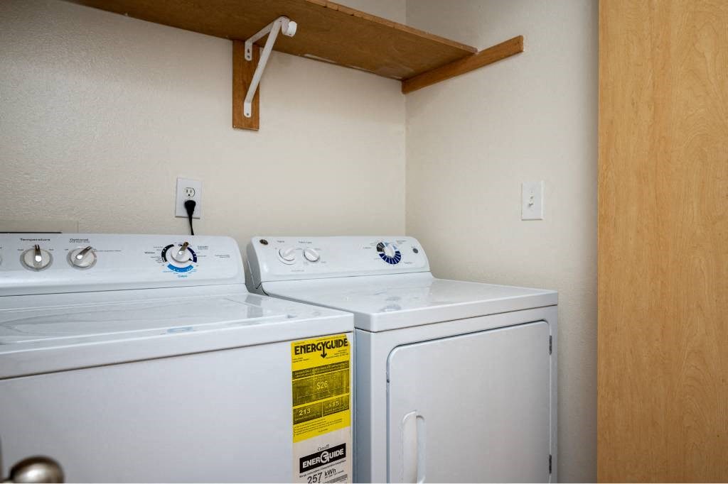 two washers and dryers in a room with a closet at Fort Vancouver Terrace, Vancouver