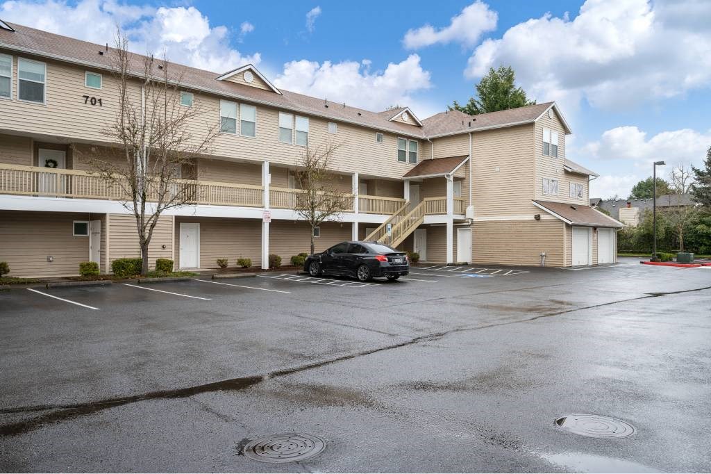 a car parked in a parking lot in front of an apartment building at Quail Run Apartments, Vancouver, Washington