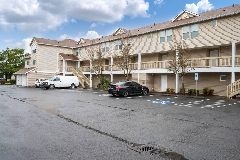 an empty parking lot in front of an apartment building at Quail Run Apartments, Vancouver, WA 98684
