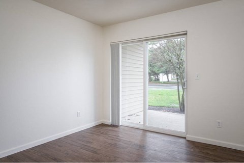 a living room with a sliding glass door to a yard