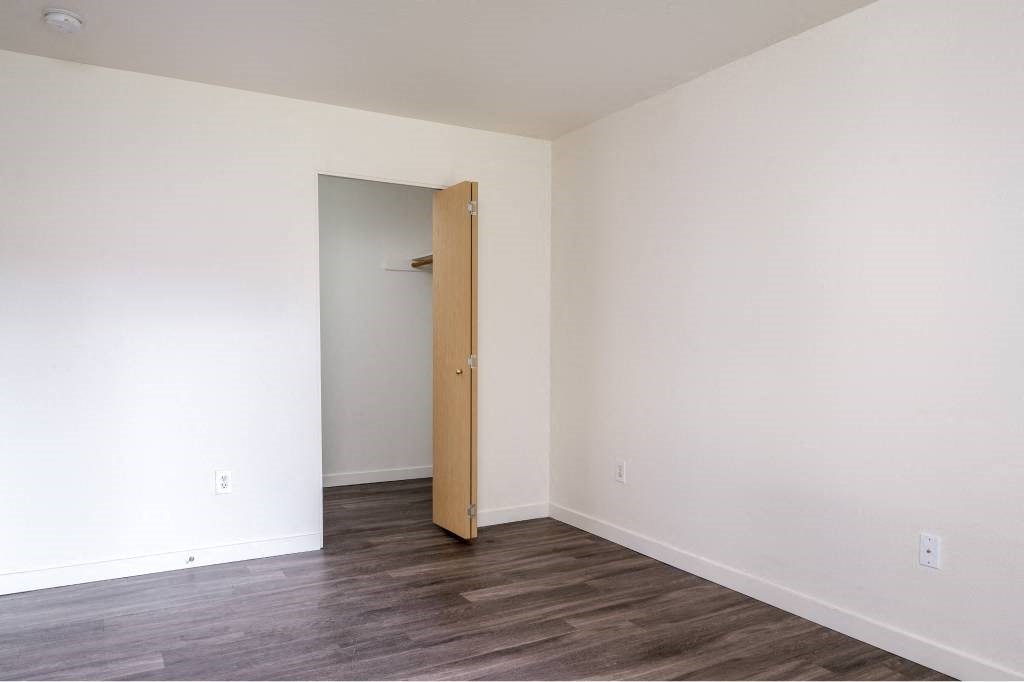an empty room with a door to a closet at Quail Run Apartments, Washington 98684