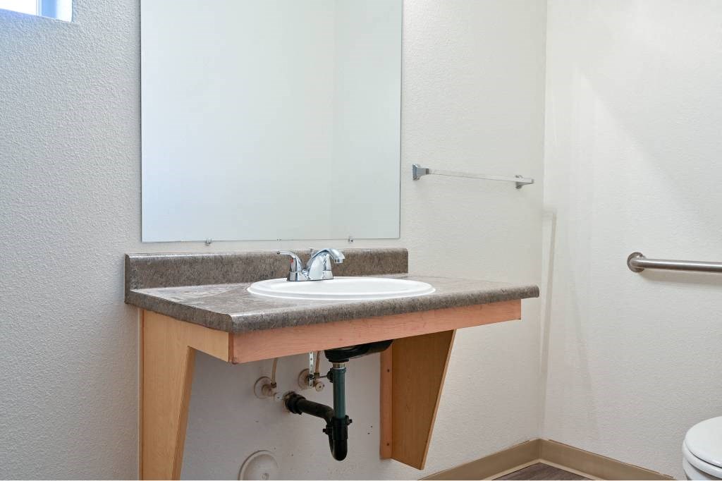 a bathroom with a sink and a mirror at Quail Run Apartments, WA