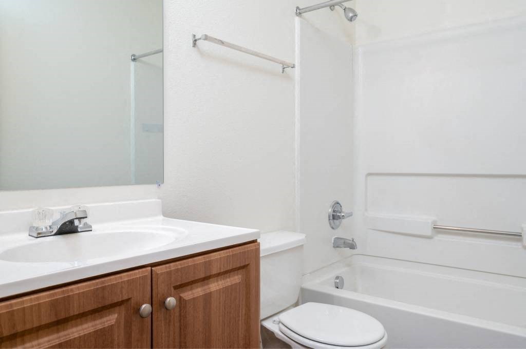 a bathroom with a sink toilet and a bath tub at Quail Run Apartments, Vancouver, WA