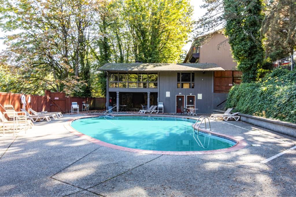 a swimming pool in front of a house at Whisperwood, Seattle, WA