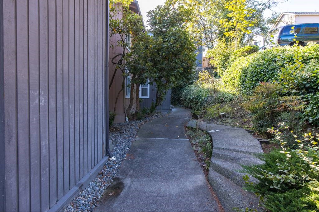 a sidewalk in front of a house at Whisperwood, Seattle, WA