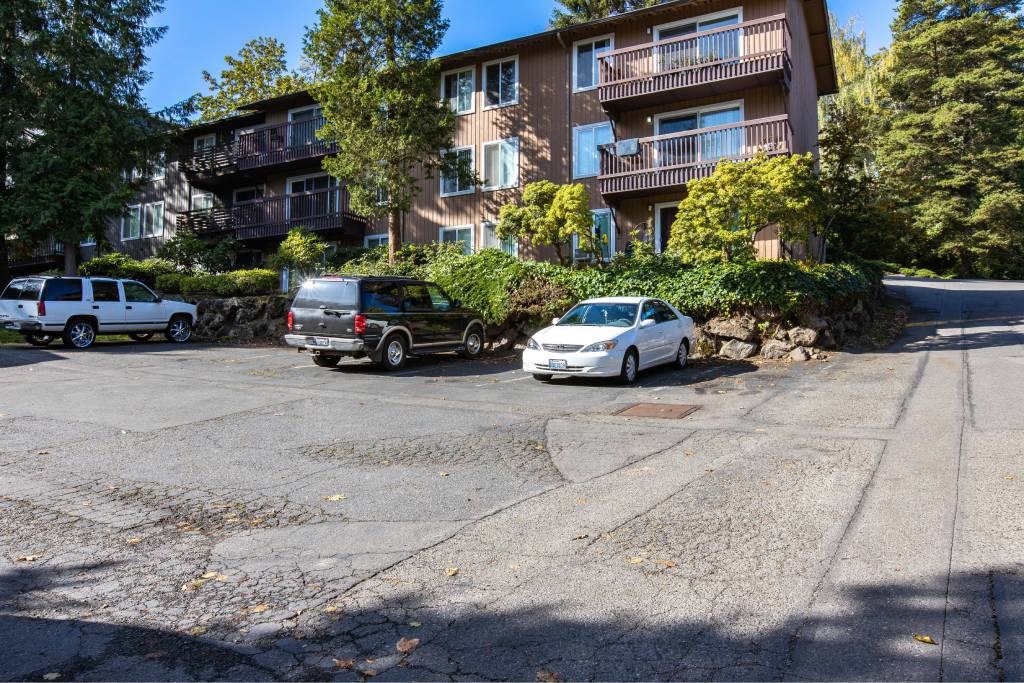 an empty parking lot in front of an apartment building at Whisperwood, Washington