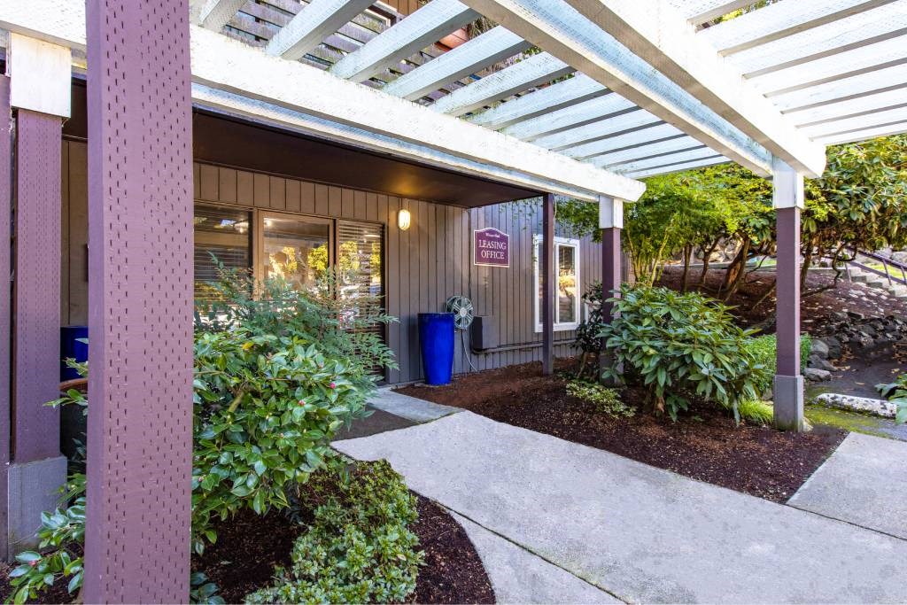 a walkway in front of a building with a porch at Whisperwood, Seattle, WA 98168