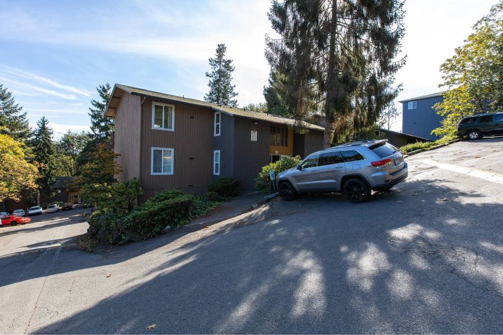a brown house with a car parked in front of it at Whisperwood, Seattle, Washington