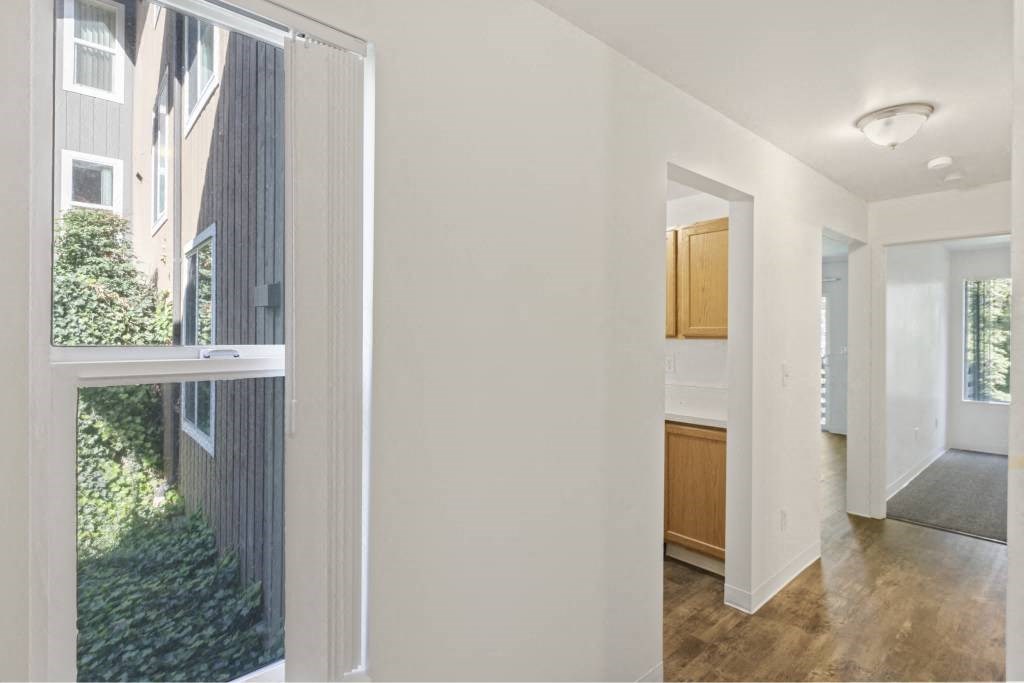 the view of a living room and a kitchen from a window at Whisperwood, Seattle, Washington