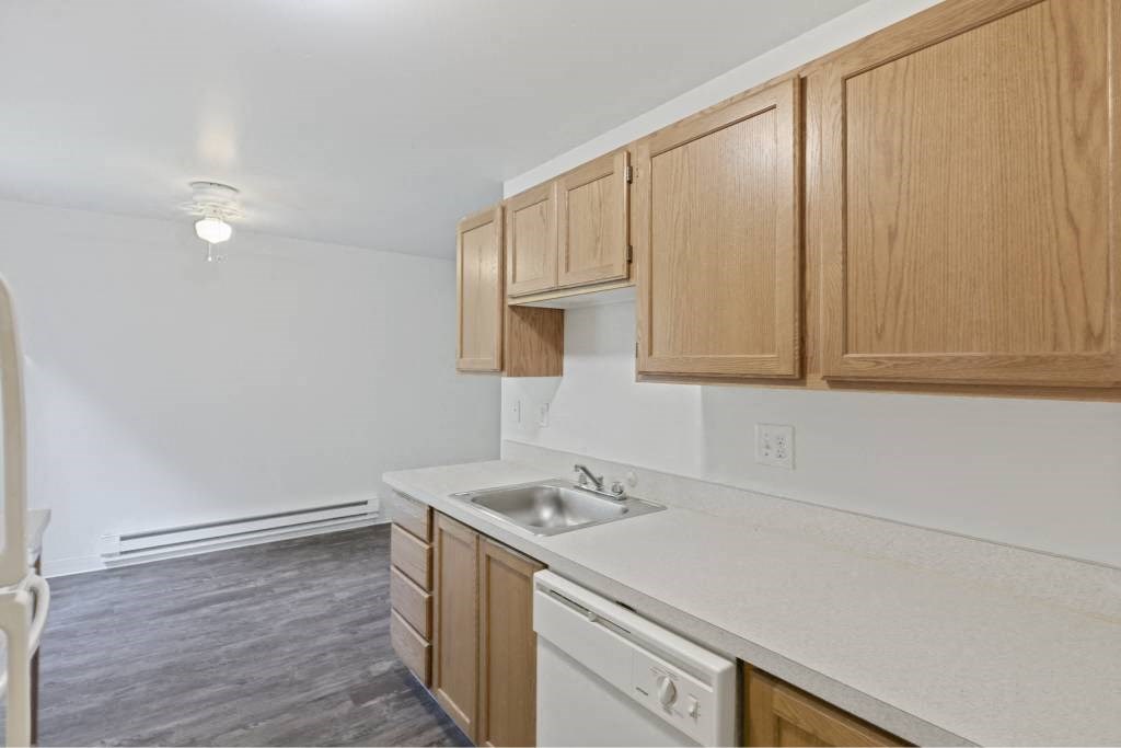 a kitchen with a sink and wooden cabinets at Whisperwood, Seattle, Washington