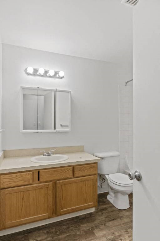 a bathroom with a toilet and a sink and a mirror at Whisperwood, Seattle, WA