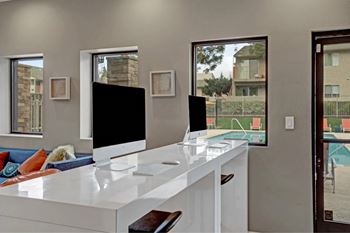 A modern living room with a white countertop and a television at The Henley Apartments, Suisun City, CA, 94585