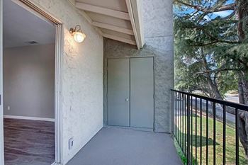 A balcony with a grey floor and a black railing at The Henley Apartments, California