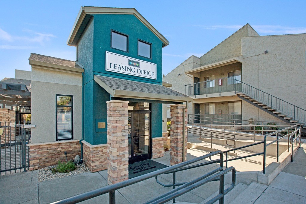 A leasing office is located in a building with a green trim. A leasing office is located in a building with a green trim at The Henley Apartments, California