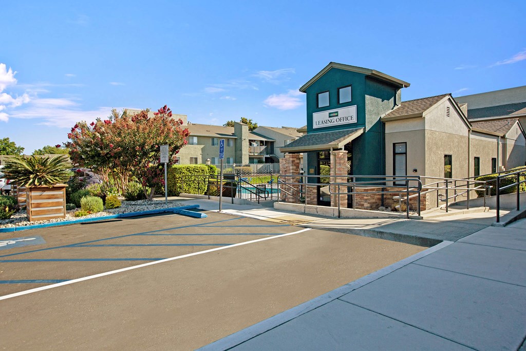 A sunny day at the entrance of a building with a sign A sunny day at the entrance of a building with a sign at The Henley Apartments, Suisun City, California