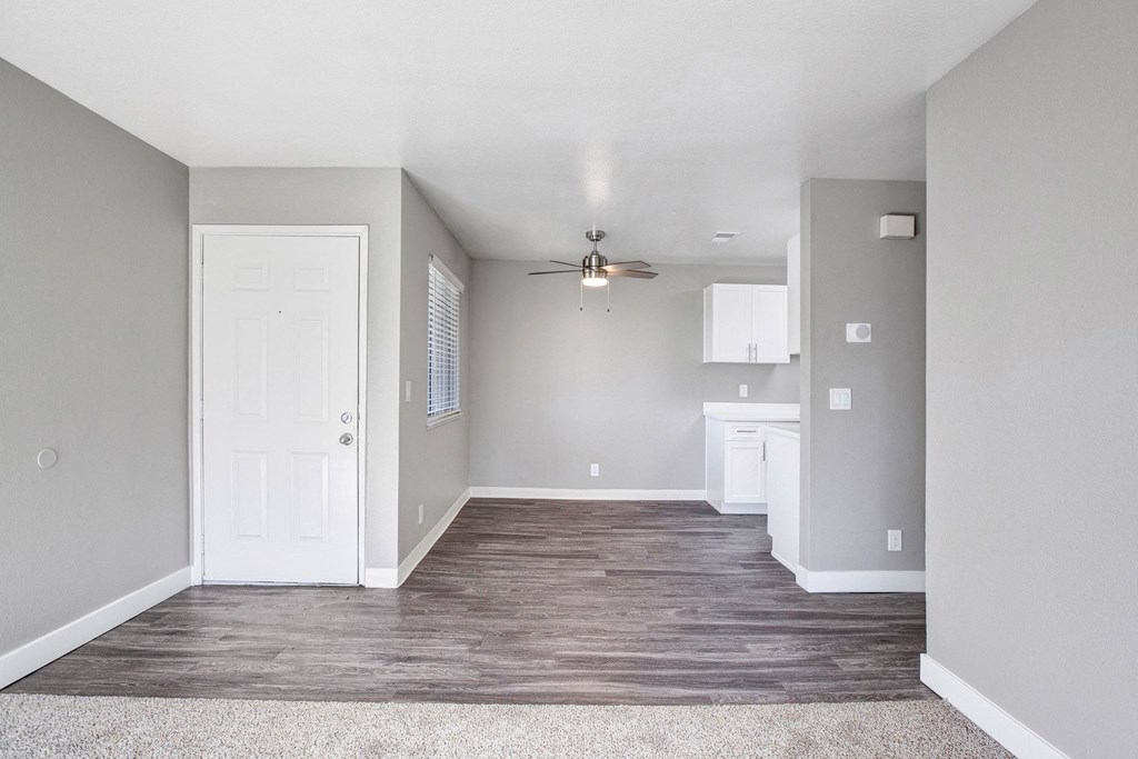A room with a white door and a ceiling fan at The Henley Apartments, Suisun City