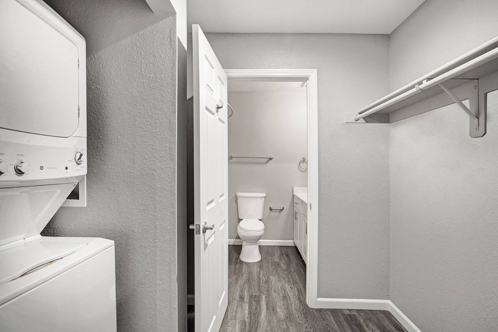 A small bathroom with a toilet and a white cabinet at The Henley Apartments, Suisun City, California