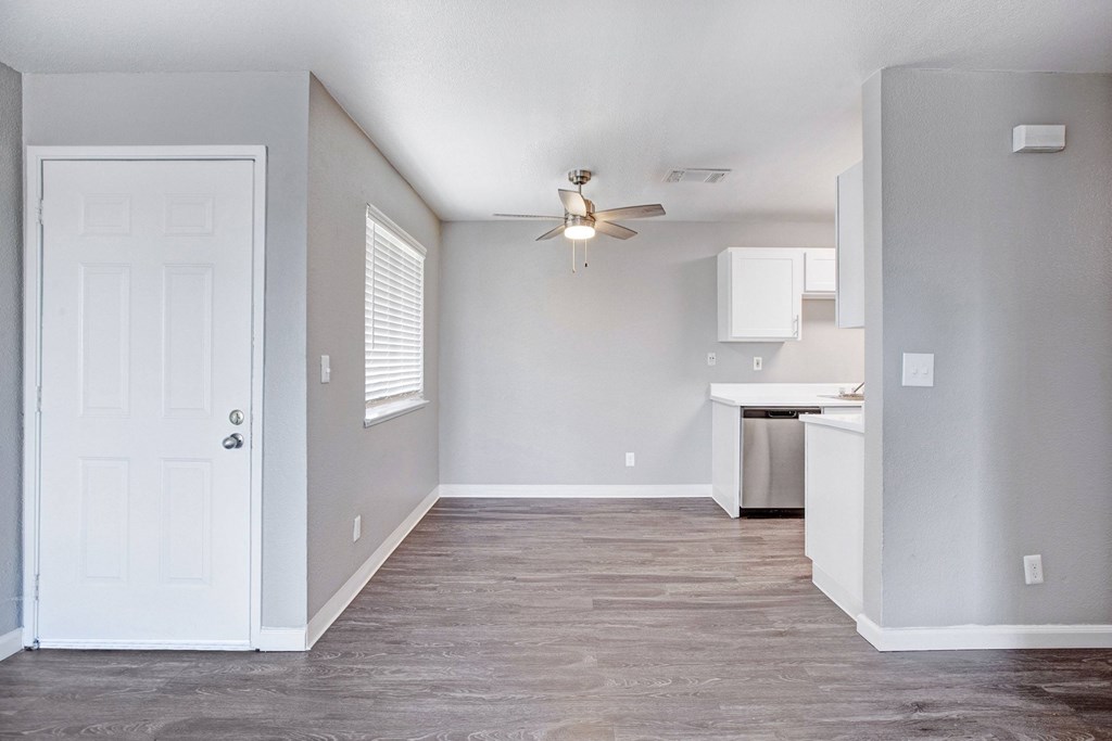 A room with a white door and a ceiling fan at The Henley Apartments, California