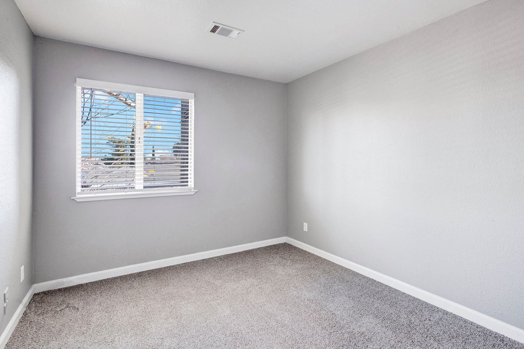 A room with a window overlooking a construction site at The Henley Apartments, Suisun City