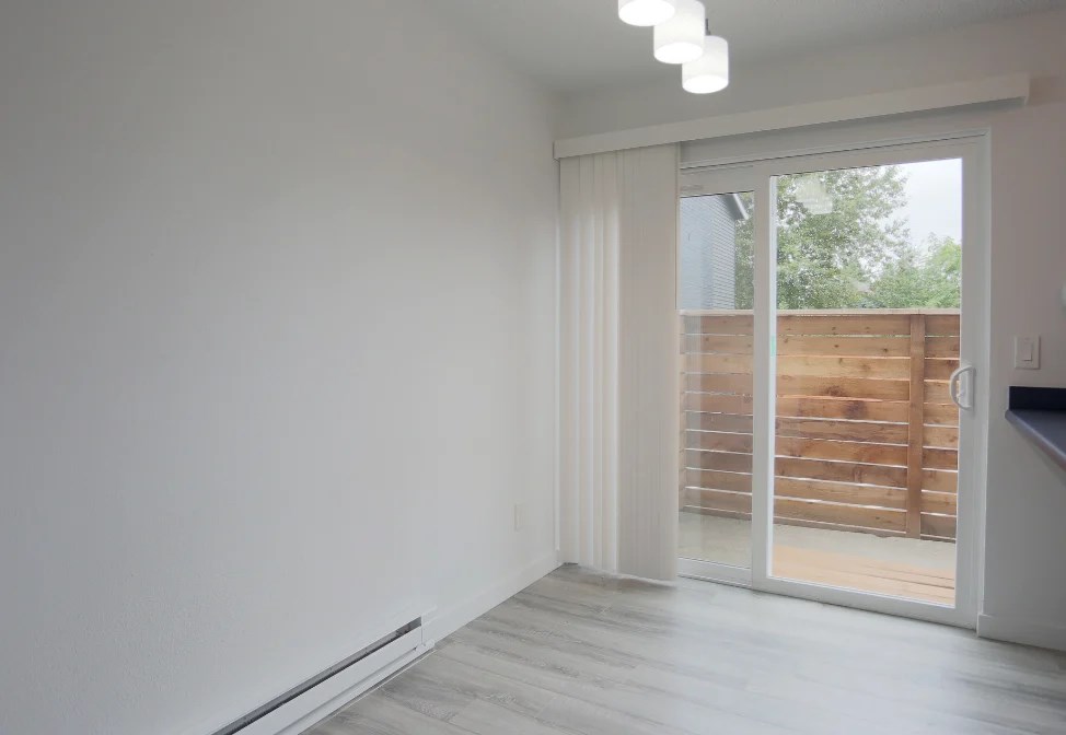 A room with a sliding door leading to a balcony.at Tigardville Apartments, Tigard