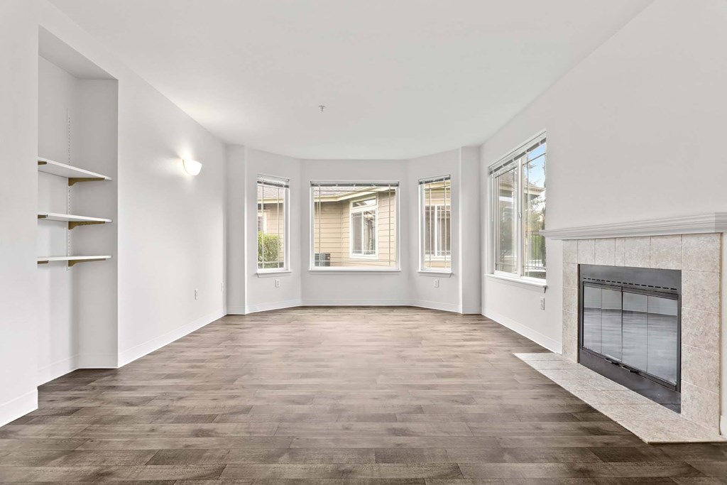 A spacious living room with a fireplace and hardwood flooring.at Maple Ridge, Vancouver, WA 98664