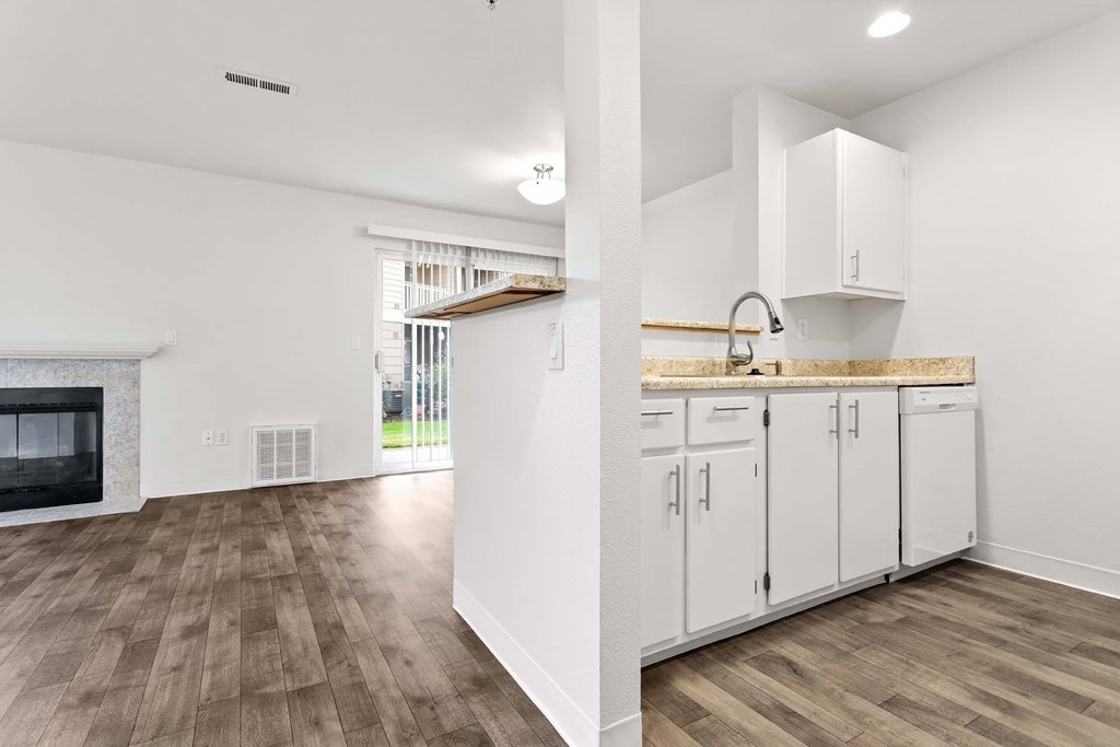 A kitchen with white cabinets and a wooden countertop.at Maple Ridge, Washington, 98664