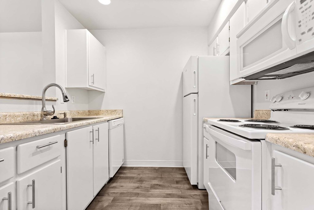 A kitchen with white appliances and cabinets.at Maple Ridge, Vancouver, 98664