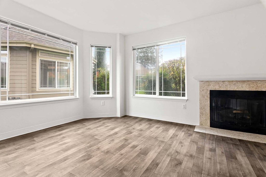 A room with a fireplace and a window.at Maple Ridge, Vancouver, 98664