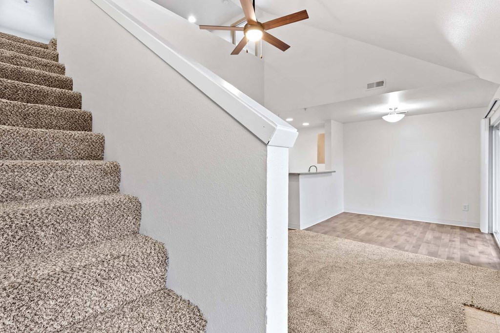 A staircase with a carpeted floor and a ceiling fan.at Maple Ridge, Vancouver, WA