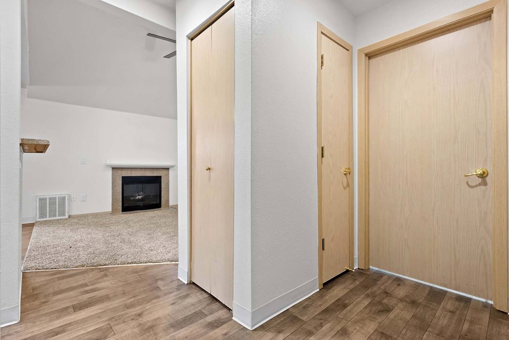 A room with a fireplace and two doors.at Maple Ridge, Vancouver