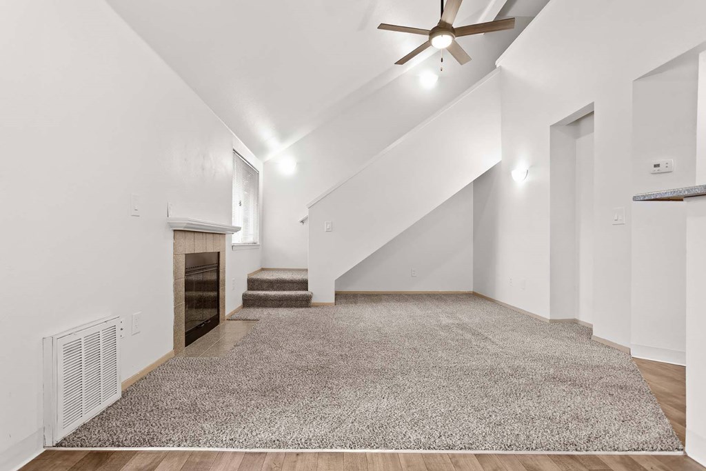 A room with a staircase and a ceiling fan.at Maple Ridge, Vancouver, WA 98664