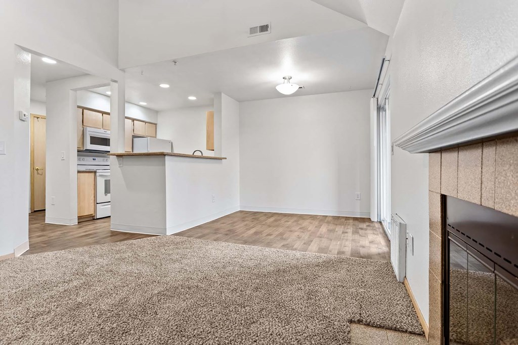 A spacious living room with a carpeted floor and a fireplace at Maple Ridge, Vancouver, 98664
